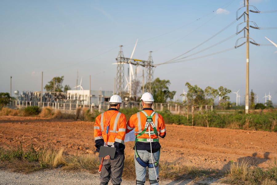 Utility engineer planning a wind turbine inspection